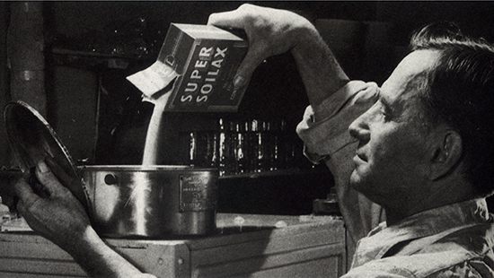 Ecolab Technician pouring Ecolab product into equipment