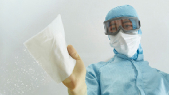 Person cleaning with Klercide wipes