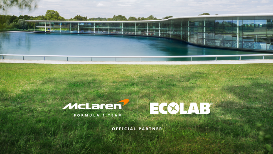McLaren Formula 1 Team and Ecolab logos on a greenery and water background around the McLaren headquarters