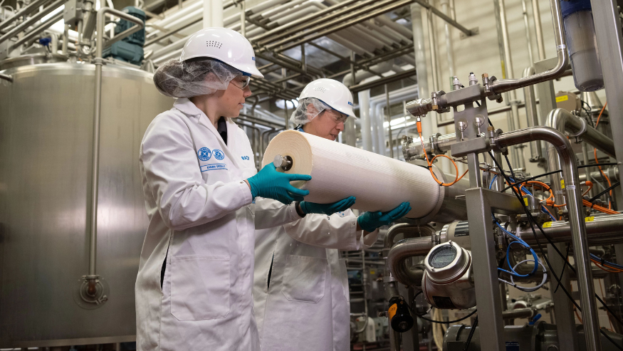Two Ecolab associates installing an Ultrasil membrane at a facility