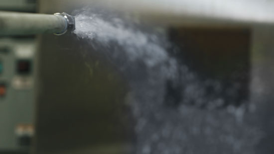 Water spraying from pressurized hose.