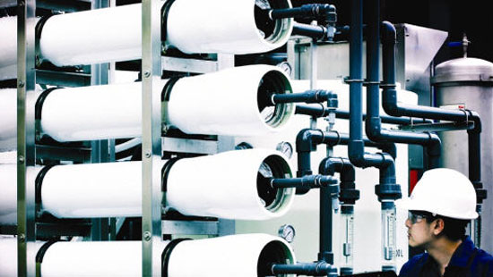 Person looking at Reverse osmosis system membrane filter set