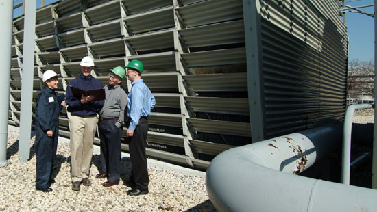 Ecolab experts with distributors in outdoor industrial setting.