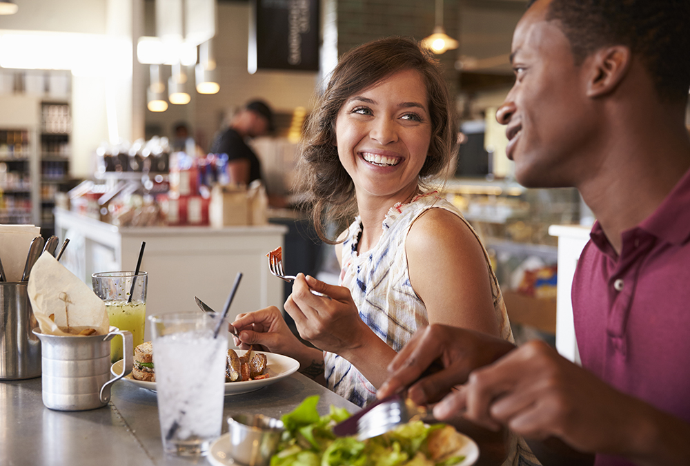 Two people eating in a restaurant