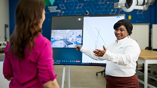 Smiling Woman in lab holding fluid - Ecolab Diversity, Equity & inclusion