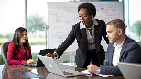 Three people outside of a factory in hard hats - Ecolab Practices & Policies