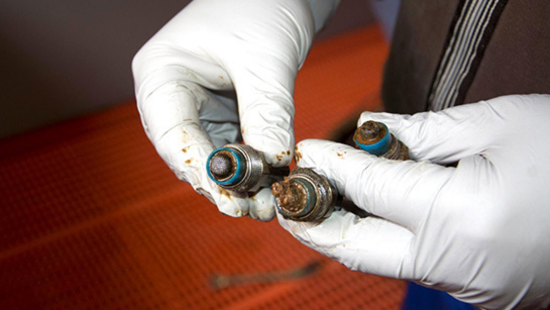 Gloved hands holding biofilm hose.