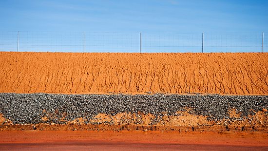 iStock-182908372 Red soil dam wall stock photo.jpg